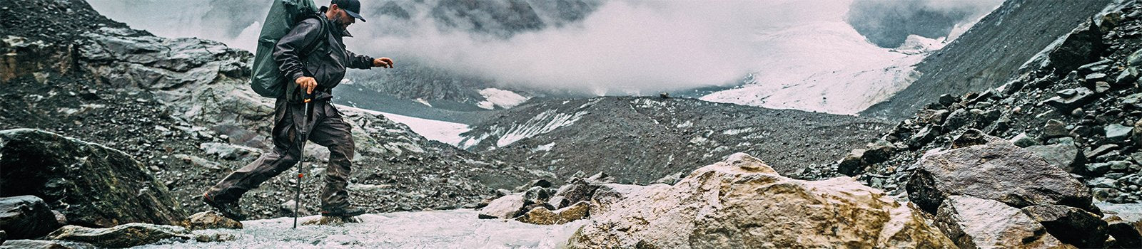 Man hiking in mountain wearing Lathrop and Sons Mountin Hunting Boots.